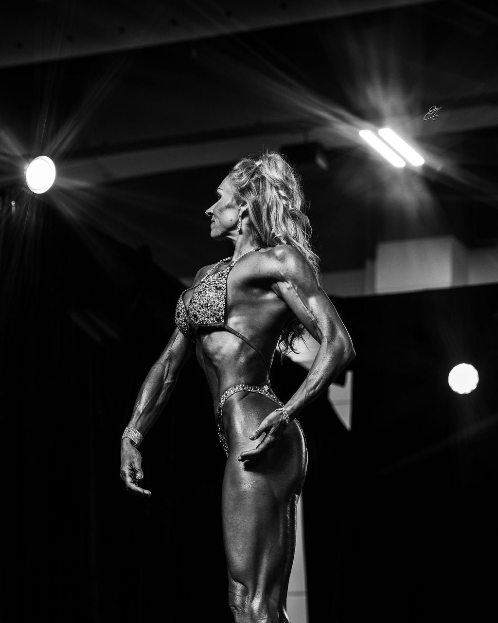 Andria Van Mierlo on stage at and NPC competition.